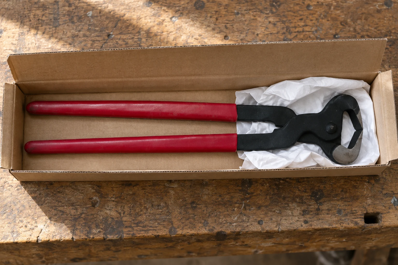 Hoof nipper secured with protective paper in a carton